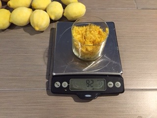 Glass of organic lemon zest on a digital food scale.